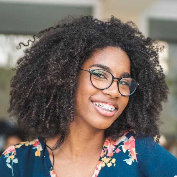 young person with traditional braces