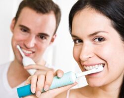 A man and women Brushing there teeths