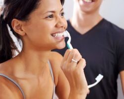 Women brushing her teeth